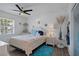 Comfortable bedroom with a ceiling fan, a plush bed, and ample natural light from the window at 5174 Beach Se Dr # B, St Petersburg, FL 33705