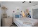 Bedroom with a light bedspread, complemented by neutral coastal decor and a ceiling fan at 5174 Beach Se Dr # B, St Petersburg, FL 33705