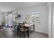 Bright dining area next to a window, with a view of the living room and kitchen space at 5174 Beach Se Dr # B, St Petersburg, FL 33705
