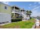 Exterior view of a two-story home with a patio, stairs, and well-manicured landscaping at 5174 Beach Se Dr # B, St Petersburg, FL 33705