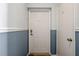 Entryway featuring a white front door and textured walls with blue and white wainscoting at 5174 Beach Se Dr # B, St Petersburg, FL 33705