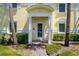 Charming condo front door entrance with palm trees, brick walkway, and lush greenery at 5174 Beach Se Dr # B, St Petersburg, FL 33705