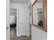 Bright hallway featuring wood floors, white trim, doors, and a decorative mirror at 5174 Beach Se Dr # B, St Petersburg, FL 33705