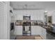 Well-lit kitchen featuring stainless steel appliances, granite counters, and ample cabinet space at 5174 Beach Se Dr # B, St Petersburg, FL 33705