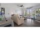 Cozy living room features a plush sofa, ceiling fan, and access to a private balcony at 5174 Beach Se Dr # B, St Petersburg, FL 33705