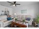 Comfortable living room with white sofas, a ceiling fan, and stylish decor accents at 5174 Beach Se Dr # B, St Petersburg, FL 33705