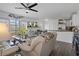 Bright living room with sliding glass doors, ceiling fan, and open concept to the kitchen at 5174 Beach Se Dr # B, St Petersburg, FL 33705