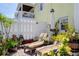 Charming patio with lounge chairs, white fence, lush potted plants, and a sunny ambiance at 5174 Beach Se Dr # B, St Petersburg, FL 33705