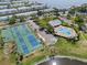 Aerial view featuring community tennis courts, a clubhouse, and a swimming pool at 5174 Beach Se Dr # B, St Petersburg, FL 33705