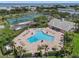 An aerial view shows the community pool, tennis courts, and lush greenery at 5174 Beach Se Dr # B, St Petersburg, FL 33705