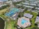 Aerial view showcasing the community pool area and tennis courts at 5174 Beach Se Dr # B, St Petersburg, FL 33705