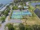 Aerial view of community tennis courts with lush landscaping and nearby clubhouse at 5174 Beach Se Dr # B, St Petersburg, FL 33705