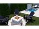 Outdoor setting with a charming fire pit surrounded by Adirondack chairs, complemented by lush greenery at 519 W Davis Blvd, Tampa, FL 33606