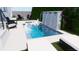 Inviting pool area with a waterfall feature, stylish lounge chairs, and well-maintained greenery at 519 W Davis Blvd, Tampa, FL 33606