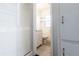 Hallway view of an all-white bathroom with a vanity at 551 84Th N Ave, St Petersburg, FL 33702