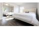 Sunlit bedroom with wood-look floors, large closet, and stylish decor at 551 84Th N Ave, St Petersburg, FL 33702