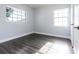 Empty bedroom with wood-look floors, two windows, and ample natural light at 551 84Th N Ave, St Petersburg, FL 33702