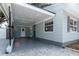 Attached carport featuring neutral colors, a side door, and access to the main house at 551 84Th N Ave, St Petersburg, FL 33702