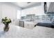 Kitchen showcasing stainless steel appliances, white cabinets, modern countertops, and a tile backsplash at 551 84Th N Ave, St Petersburg, FL 33702