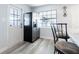 Kitchen featuring stainless steel appliances, white cabinetry, light-colored wood floors, and a side door at 551 84Th N Ave, St Petersburg, FL 33702