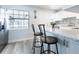 Bright kitchen with white cabinets, a stone backsplash, stainless steel appliances, and wood-look floors at 551 84Th N Ave, St Petersburg, FL 33702
