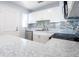 Bright kitchen featuring white cabinets, tile backsplash, and stainless steel dishwasher and a stainless steel stove at 551 84Th N Ave, St Petersburg, FL 33702