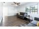 Sunlit living room showcasing hardwood floors and comfortable gray sofa at 551 84Th N Ave, St Petersburg, FL 33702