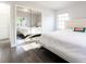 Bright bedroom with modern finishes, wood-look floors, and mirrored closet at 551 84Th N Ave, St Petersburg, FL 33702
