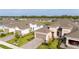 Aerial view of the home showcasing landscaping, a brick driveway, and two-car garage plus a one-car garage at 5735 Mezzana Run, Palmetto, FL 34221