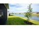 A large pond and well-maintained green grass in the backyard creates a serene setting at 5735 Mezzana Run, Palmetto, FL 34221