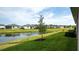 A large pond and well-maintained green grass in the backyard creates a serene setting at 5735 Mezzana Run, Palmetto, FL 34221