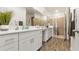 Spa-like bathroom featuring double sinks, quartz countertops and a glass-enclosed shower at 5735 Mezzana Run, Palmetto, FL 34221