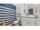 Neat bathroom featuring a toilet, vanity with storage, and a shower with stylish curtain at 5735 Mezzana Run, Palmetto, FL 34221