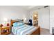 Well-lit bedroom features a comfy bed and offers a glimpse into the en-suite bathroom at 5735 Mezzana Run, Palmetto, FL 34221