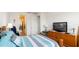 This bedroom is bright, with a wooden dresser and a comfortable bed at 5735 Mezzana Run, Palmetto, FL 34221