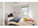 This bedroom features natural light, a comfortable bed, and stylish minimalist shelving at 5735 Mezzana Run, Palmetto, FL 34221