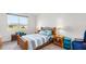 Well-lit bedroom with a neutral color scheme and a large window at 5735 Mezzana Run, Palmetto, FL 34221