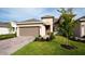 Charming single-story home featuring a paver driveway, two-car garage, and well-manicured landscaping at 5735 Mezzana Run, Palmetto, FL 34221