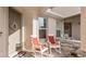 Relaxing front porch features two white rocking chairs with red cushions for enjoying the outdoors at 5735 Mezzana Run, Palmetto, FL 34221