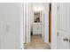 Hallway with a view of the bathroom featuring a vanity and sink with wood-look flooring at 5735 Mezzana Run, Palmetto, FL 34221