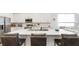 Kitchen with an island with seating, quartz countertops, and stainless steel appliances at 5735 Mezzana Run, Palmetto, FL 34221