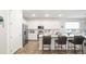 Modern, all-white kitchen with stainless steel appliances, large island, and bar stool seating at 5735 Mezzana Run, Palmetto, FL 34221