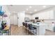 Spacious kitchen featuring white cabinets, stainless steel appliances, and a large island with bar seating at 5735 Mezzana Run, Palmetto, FL 34221