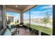 Beautiful screened lanai with brick flooring, seating, and a view of the pond at 5735 Mezzana Run, Palmetto, FL 34221