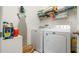 Functional laundry room with modern appliances, storage shelves and space-saving design at 5735 Mezzana Run, Palmetto, FL 34221