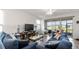 Comfortable living room features a large TV, plush sofas, and access to the patio at 5735 Mezzana Run, Palmetto, FL 34221