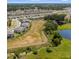 Extensive view of the real estate location, showcasing community amenities, pond, and greenery at 7018 Ripple Pond Loop, Zephyrhills, FL 33541
