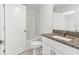 Bathroom featuring a shower/tub combination with tiled walls and vanity with granite counters at 7018 Ripple Pond Loop, Zephyrhills, FL 33541