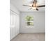 Bedroom featuring neutral carpet, a ceiling fan, and a closet at 7018 Ripple Pond Loop, Zephyrhills, FL 33541