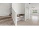 Inviting hallway featuring a study nook, closet and carpeted staircase that leads to the upper level at 7018 Ripple Pond Loop, Zephyrhills, FL 33541
